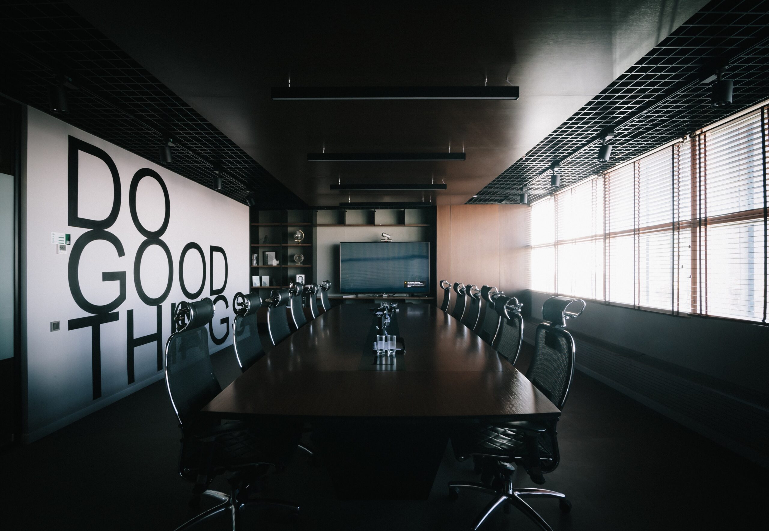Empty board room with positive message on the wall